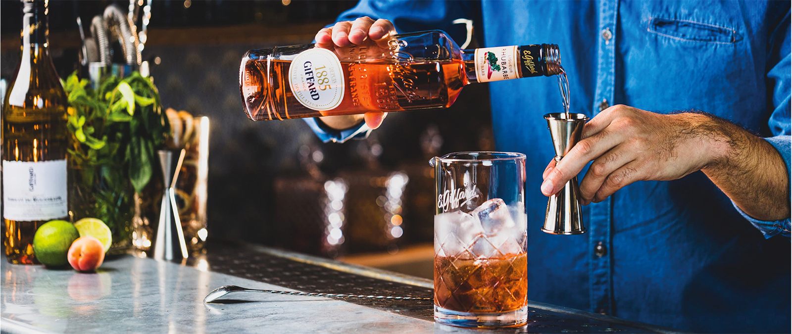 A bartender prepares a cocktail with Giffard